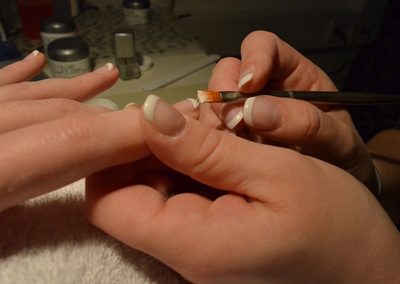 French manicure being applied at the nail salon