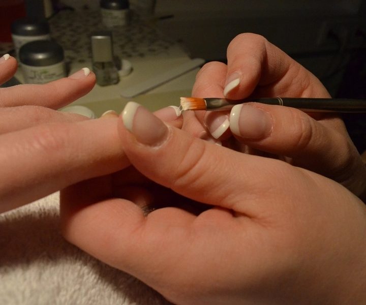 French manicure being applied at the nail salon