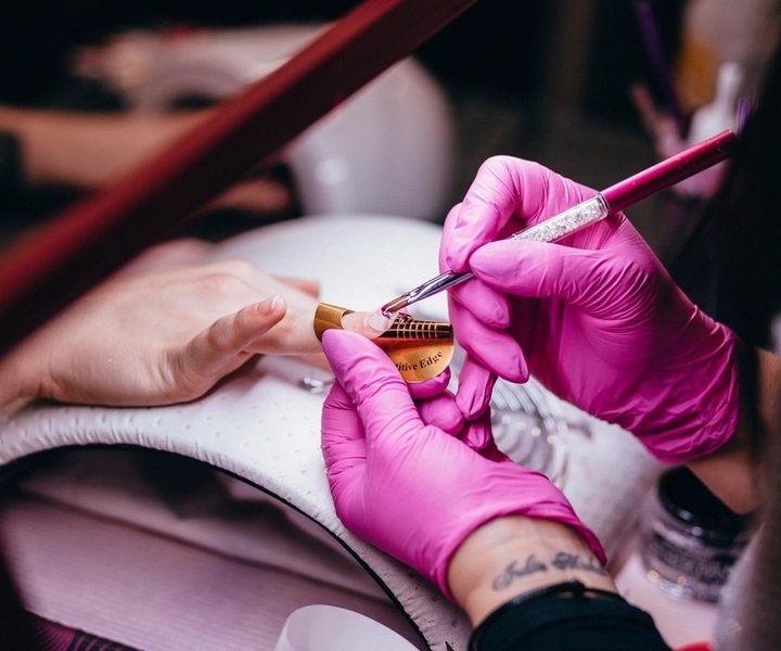 Nail artist painting a custom nail art design