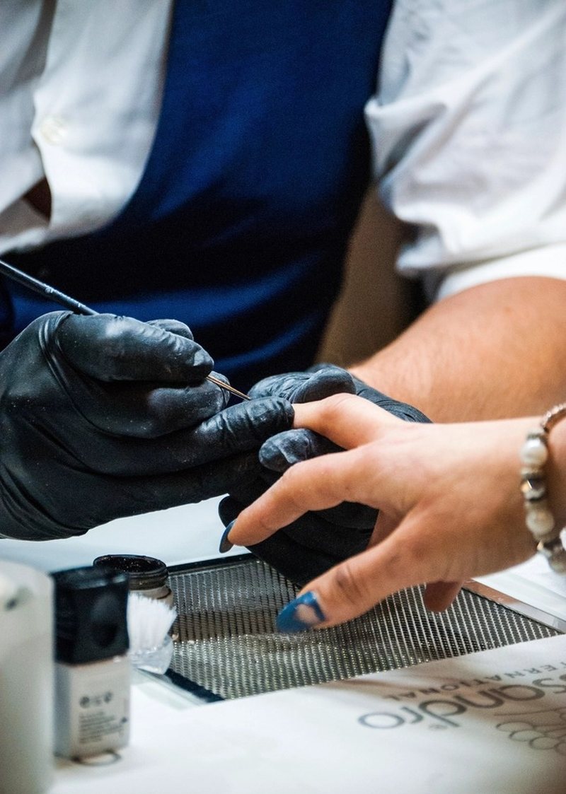 Nail technician giving a manicure at Luxx Nail Lounge in Hendersonville, NC